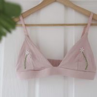 overview of the pink bralette with hand embroidered daisies
