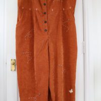 Copper/brown jumpsuit with bees, butterflies, and mushrooms