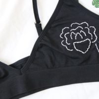 close up of the hand embroidered white rose