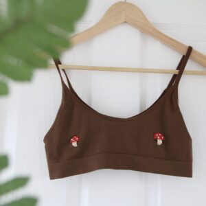 A brown bralette hand embroidered with toadstool mushrooms