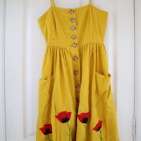 A yellow dress hand embroidered with 4 red poppies