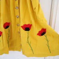 Hand embroidered red poppies on a yellow dress