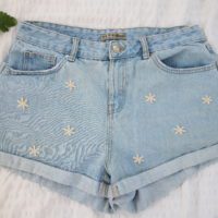 Hand embroidered blue denim shorts with white daisies