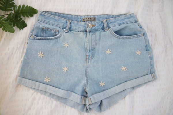 Hand embroidered blue denim shorts with white daisies