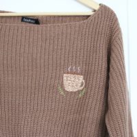 hand embroidered coffee cup on a brown jumper