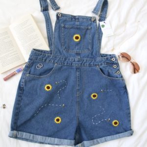 Flatlay of the Winnie overalls embroidered with sunflowers and bees