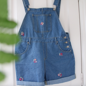Blue denim overall shorts hand embroidered with pink scattered blossom