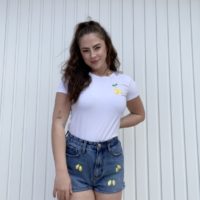 brunette girl wearing hand embroidered lemon shorts and a matching tshirt