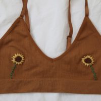 overview of the brown bralette with two hand embroidered sunflowers