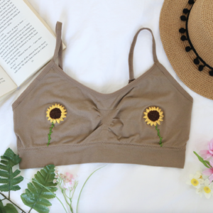 A brown bralette hand embroidered with sunflowers