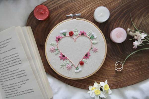 Embroidered heart surrounded by wildflowers