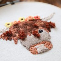 close up of the turkey stitch work on a hand embroidered highland cow