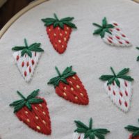close up of hand embroidered strawberries