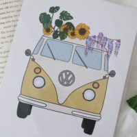 close up of the yellow camper van, sunflowers, monsteras and wisteria flowers