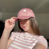 brunette model wearing the pink floral cap