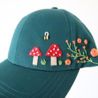 Close up embroidered toadstool mushrooms and bee