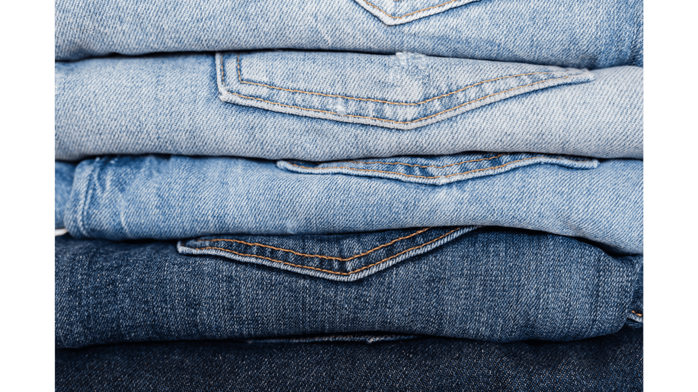 A neatly folded piled of denim jeans