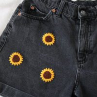 Close up of the left side of the embroidered sunflower shorts