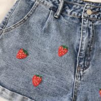 close up of the left side of the shorts embroidered with strawberries