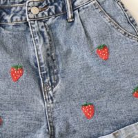 close up of the right side of the shorts and embroidered strawberries