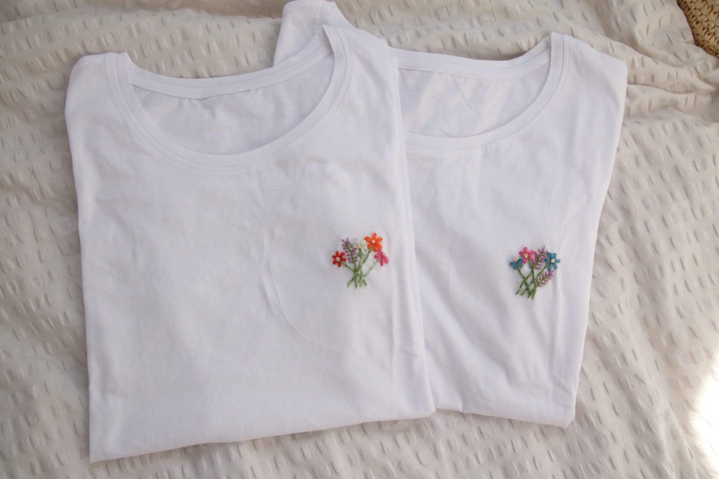 2 white t-shirts with flower bouquets hand embroidered on the left breast