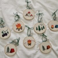 a collection of 8 hand embroidered 3 inch hoop decorations inspired by camping and nature