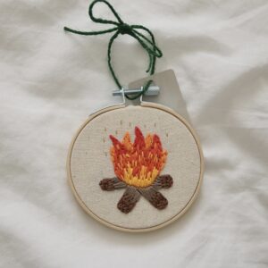 hand embroidered 3 inch decoration with a campfire and gold flecks
