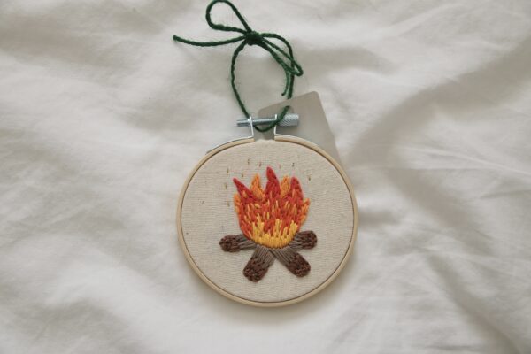 hand embroidered 3 inch decoration with a campfire and gold flecks