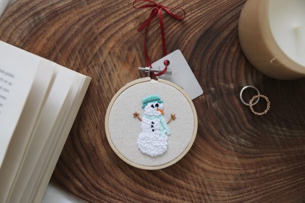 Christmas tree decoration hand embroidered with a snowman wearing a hat and scarf