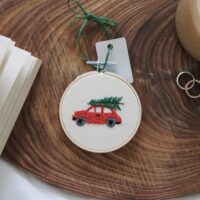 Christmas tree hand embroidered with a red car and tree on top