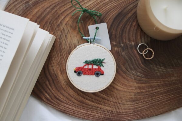 Christmas tree hand embroidered with a red car and tree on top