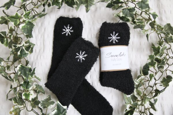 black fluffy socks hand embroidered with white snowflakes