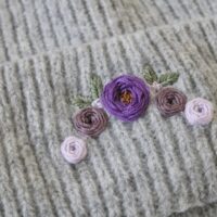 close up of hand embroidered purple roses