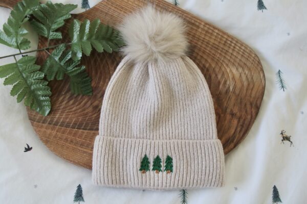 Cream beanie hand embroidered with 3 evergreen trees