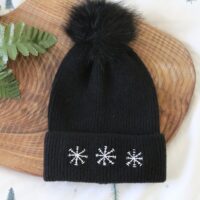 Black beanie hand embroidered with 3 white snowflakes