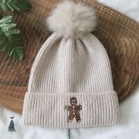 Cream beanie hand embroidered with a gingerbread man