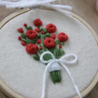 Close up of stitches of a rose bouquet tied with ribbon