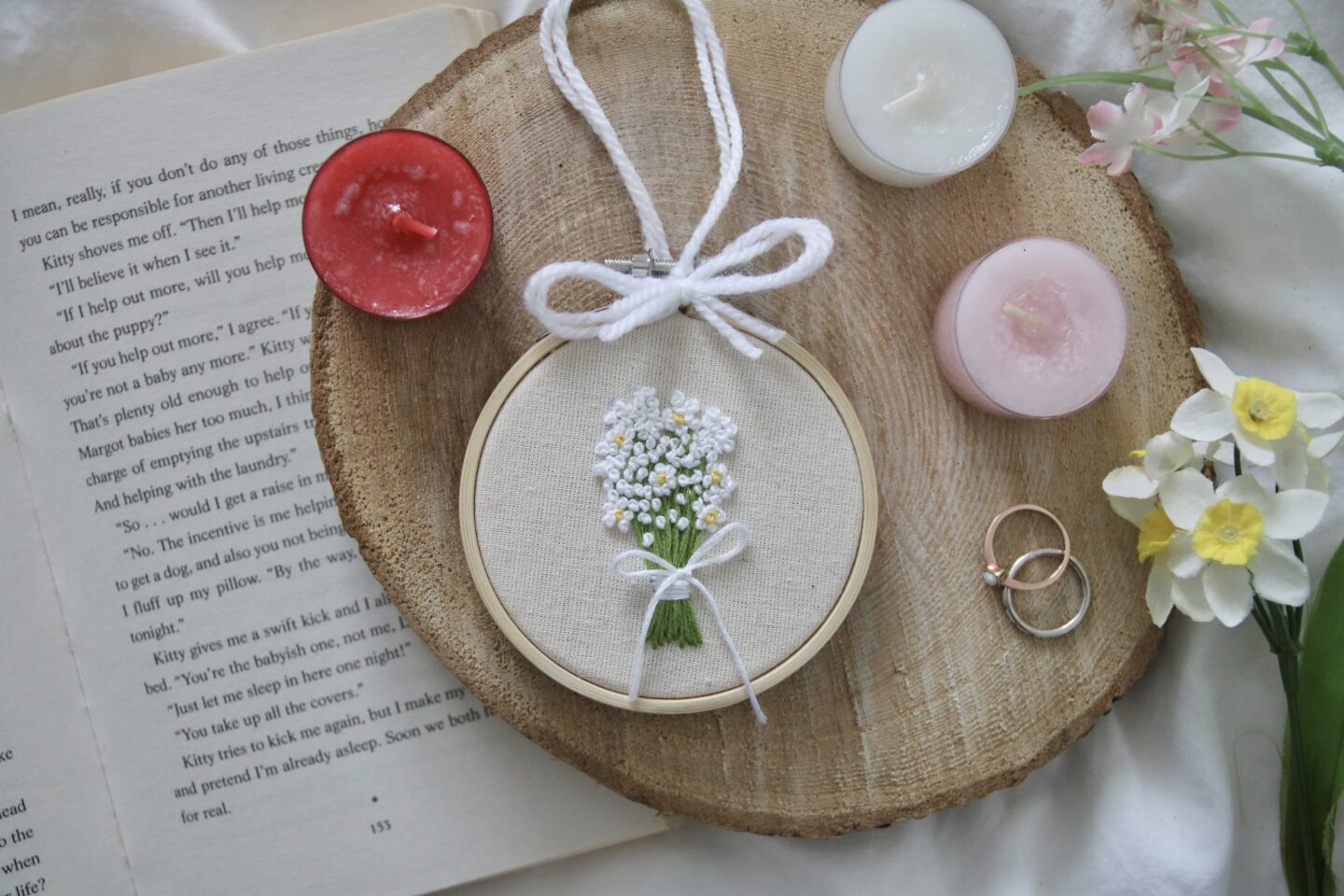 A three inch embroidery hoop hand embroidered with a gypsophila bouquet of flowers