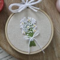 A hand embroidered bouquet of flowers of baby's breath
