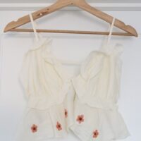 A floaty white top hand embroidered with pink cherry blossom