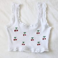 A white frill crop top hand embroidered with cherries