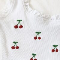 Hand embroidered red cherries on a white crop top