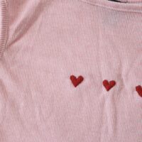 Hand embroidered red hearts on a pink and white striped top