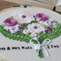 Hand embroidered purple flowers and green vines