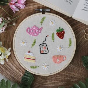 A 6 inch decor hoop hand embroidered with afternoon tea themed delights