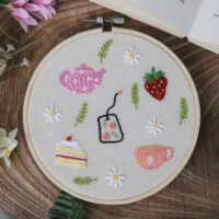 A 6 inch decor hoop hand embroidered with afternoon tea themed delights