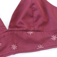 hang embroidered dusty red hued flowers on a deep red bralette