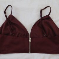 A silver zipped back to a deep red coloured bralette