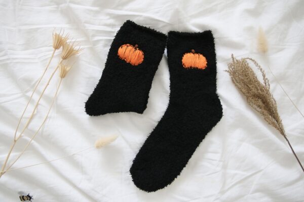 Black fluffy socks with hand embroidered orange pumpkins