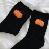 Black fluffy socks with hand embroidered orange pumpkins